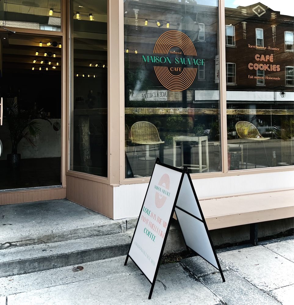 Devanture de Maison Sauvage Café rue Bernard : vitrine au logo doré, enseigne Café Cookies et affiche sur le trottoir.